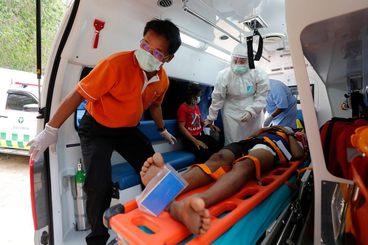 An injured Karen villager from Myanmar is attended to by medical workers after crossing the Salawin river on a boat, at Ban Mae Sam Laep Health Center, Mae Hong Son province, Thailand, March 30. The weekend strikes by the Myanmar military, which sent ethnic Karen people seeking safety in Thailand, represented another escalation in the violent crackdown by Myanmar’s junta on protests of its Feb 1 takeover. Photo: AP
