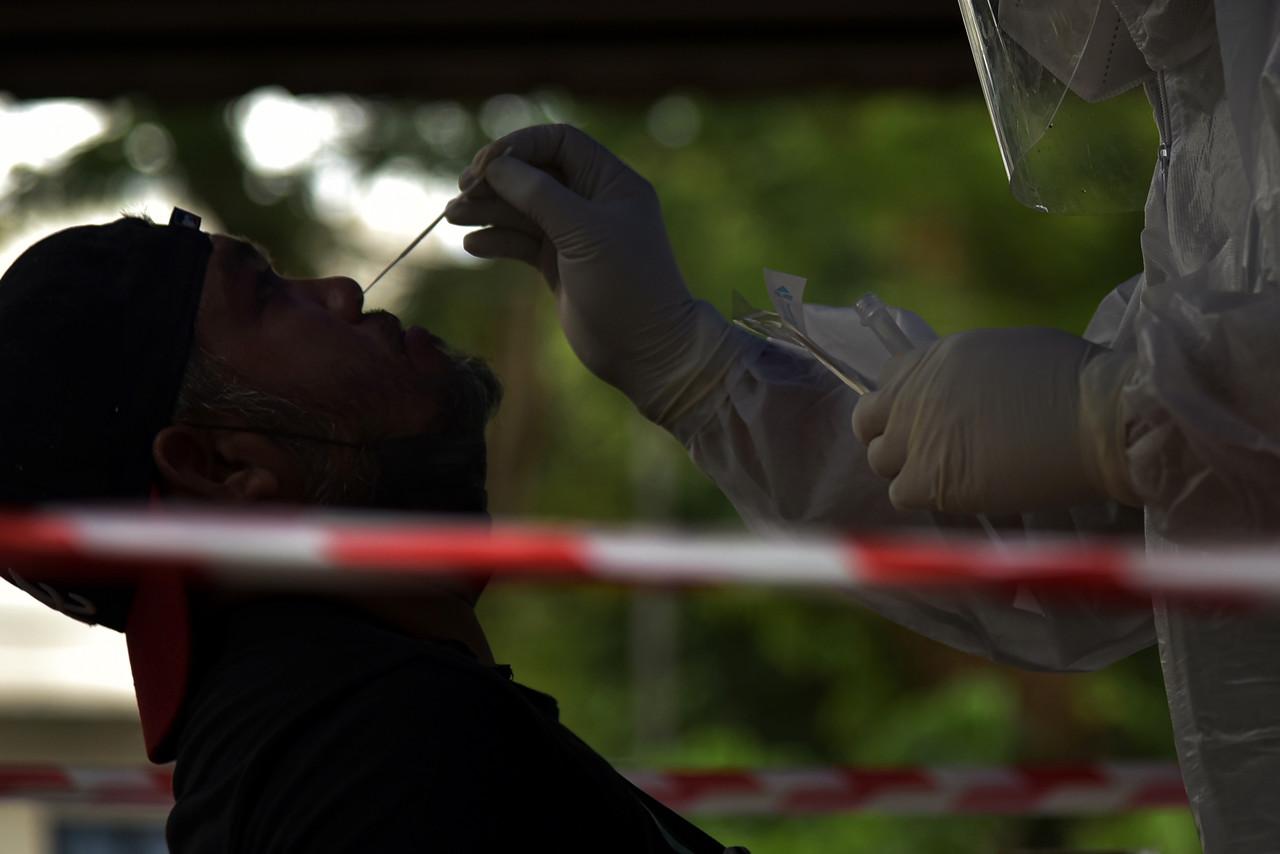 A health worker takes a swab sample to be tested for Covid-19 at a clinic in Labuan today. Photo: Bernama