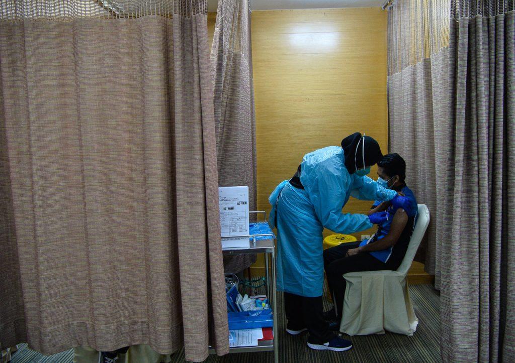 A staff member at KPJ Tawakkal receives his first dose of the Pfizer-BioNTech vaccine in Kuala Lumpur on March 15. Photo: Bernama