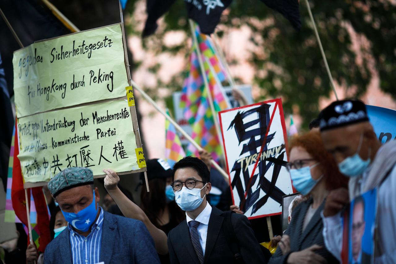 Hong Kong activist Nathan Law (centre) takes part in a protest during the visit of Chinese Foreign Minister Wang Yi in Berlin, Germany, Sept 1, 2020. Photo: AP