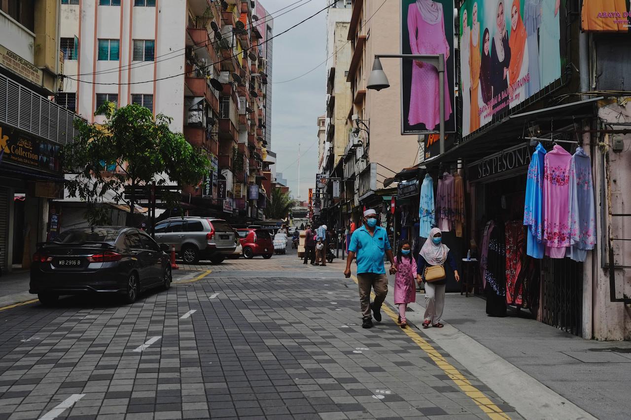 A family strolls along Jalan Tunku Abdul Rahman in Kuala Lumpur ahead of Ramadan which begins next week. Photo: Bernama