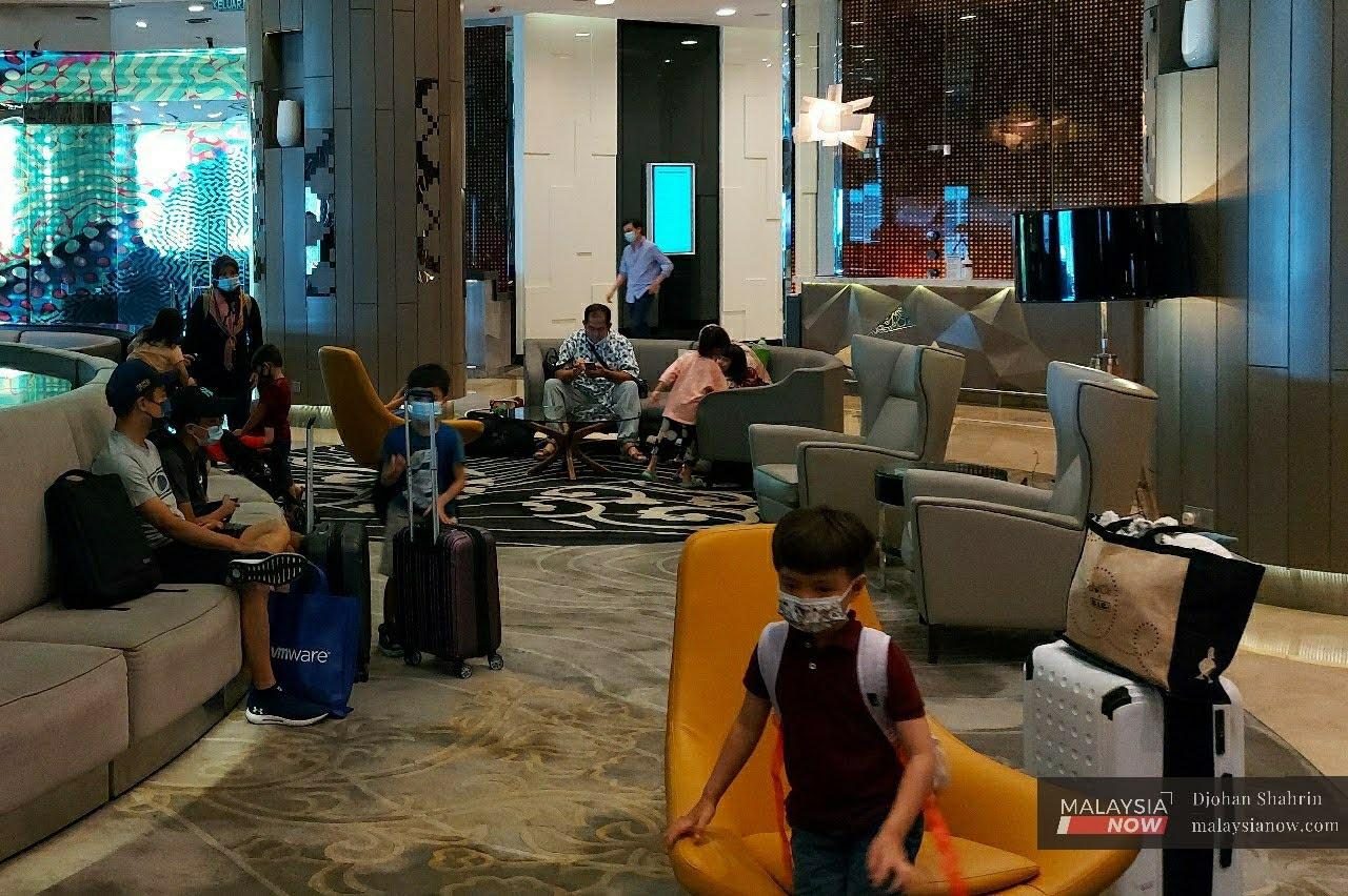 Guests wait at the lobby of a hotel in Kuala Lumpur. Hotel reservations have been on the rise at many establishments in the capital city since its transition to conditional movement control order.