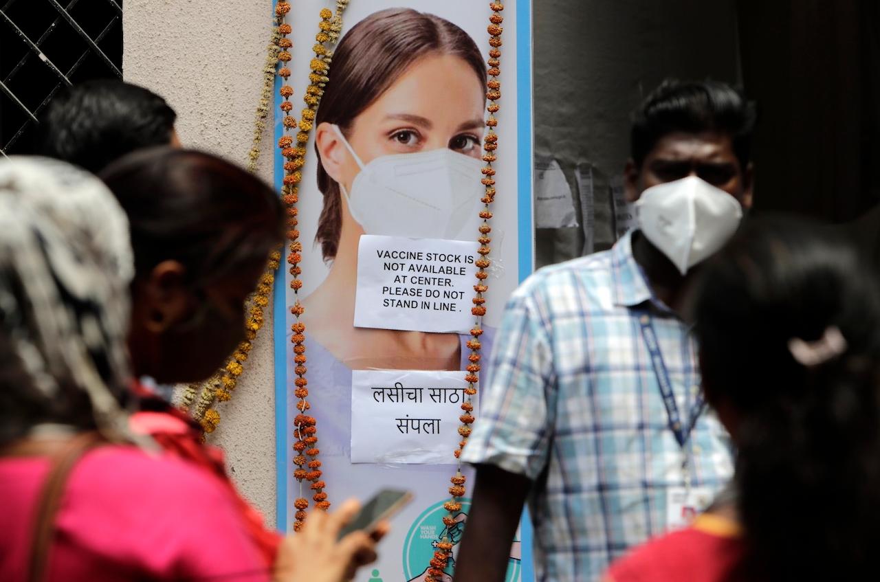 People wait outside a vaccination centre which has been closed because of shortage of the Covid-19 vaccine in Mumbai, India, April 9. India has a seven-day rolling average of more than 100,000 cases per day and has reported 13 million virus cases since the pandemic began, the third-highest total after the US and Brazil. Photo: AP