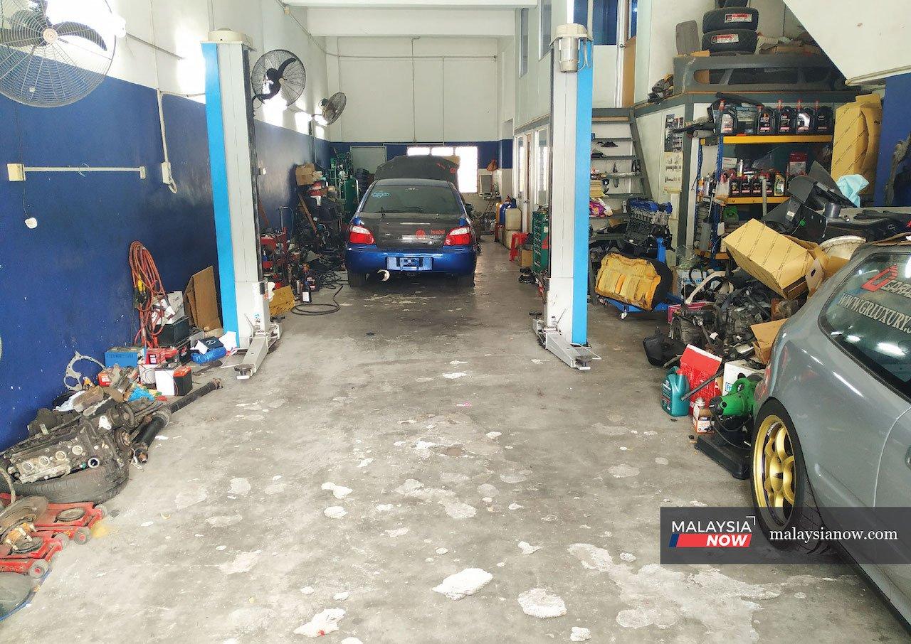 A few cars wait in line at a workshop in Shah Alam. Its owner David says car owners no longer visit traditional workshops as much unless they get a recommendation from a friend or a family member.