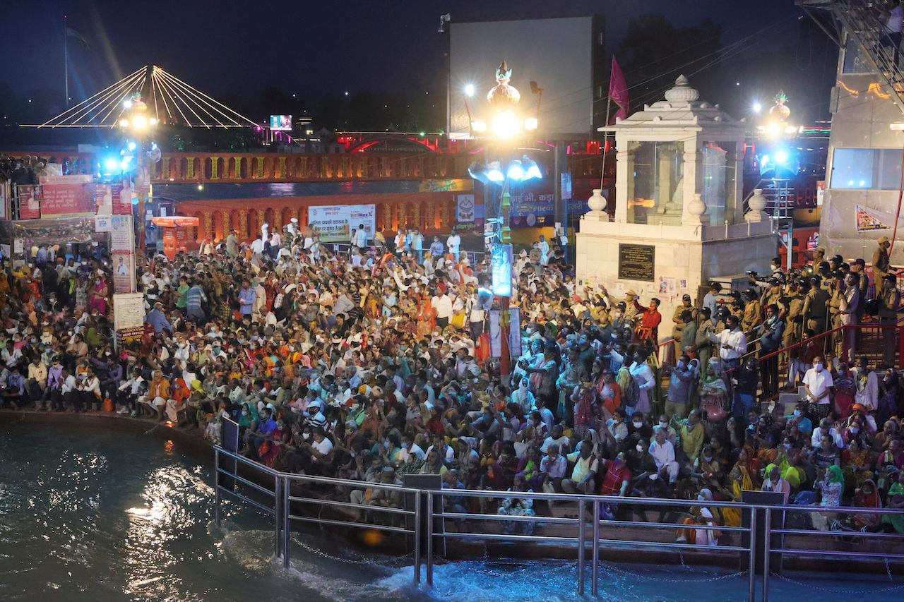 Devotees sit and pray in the evening on the ghats of the Ganges River during Kumbh Mela, or pitcher festival, one of the most sacred pilgrimages in Hinduism, in Haridwar, northern state of Uttarakhand, India, April 12. Photo: AP