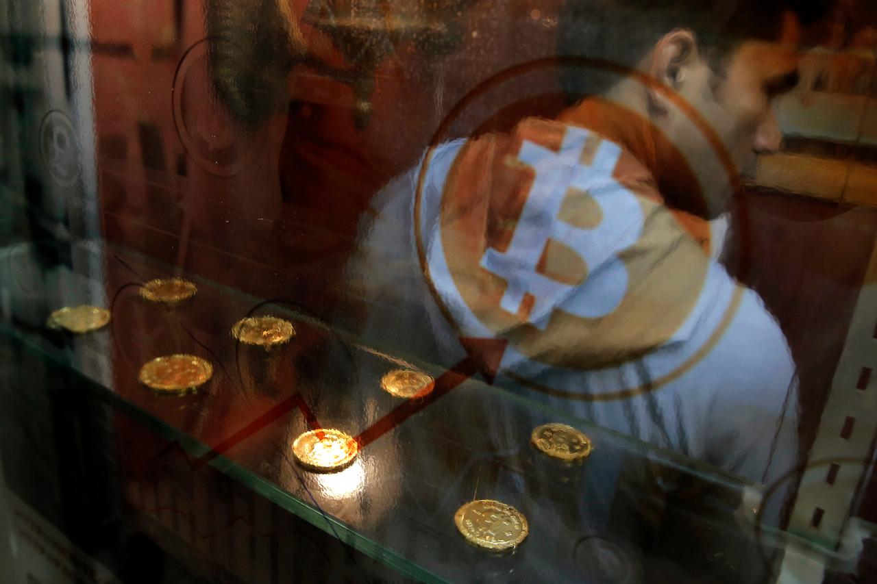 In this Dec 8, 2017, file photo, a man uses a Bitcoin ATM in Hong Kong. Cryptocurrency exchange Coinbase will be the first company devoted entirely to cryptocurrency to enter the US stock exchange. Photo: AP