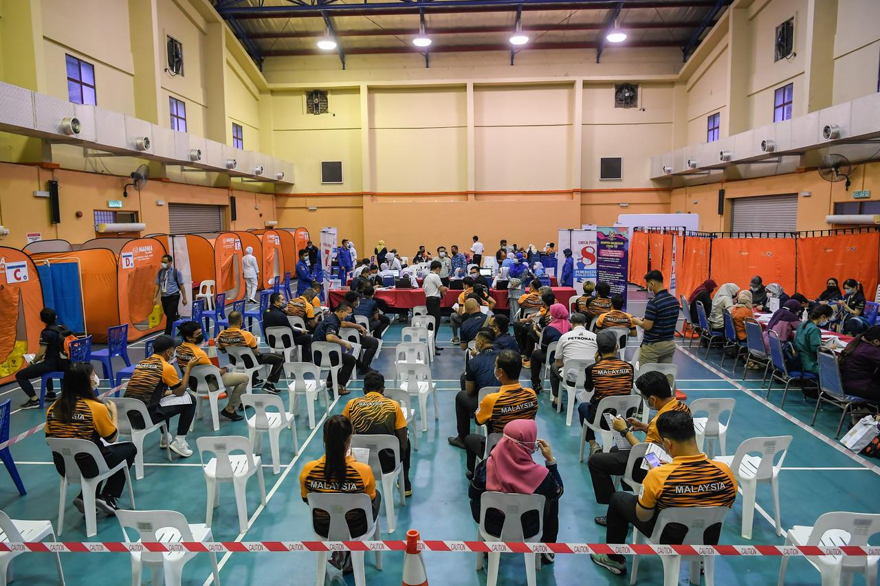 Athletes wait for their turn to receive the Pfizer-BioNTech vaccine for Covid-19 at the Kuala Lumpur City Hall Sports Complex today. Photo: Bernama