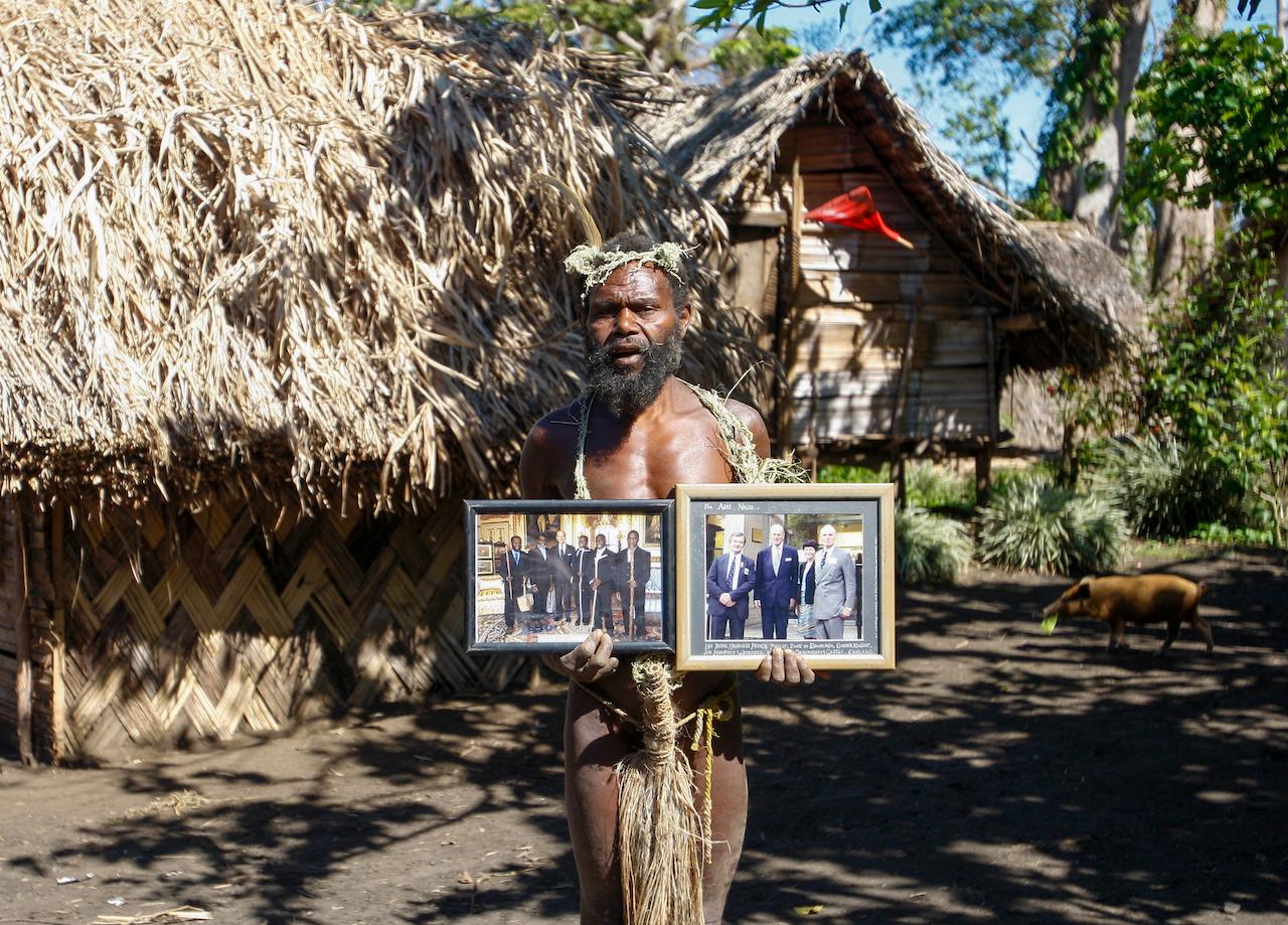 A tribesman in Yakel on the remote island of Tanna, Vanuatu, holds up photos of Prince Philip in this May 31, 2015 file picture. The group, based in villages on the island of Tanna in the former Anglo-French colony, revered the duke of Edinburgh and believed him to be a reincarnation of an ancient warrior who left the island to fight a war. Photo: AP