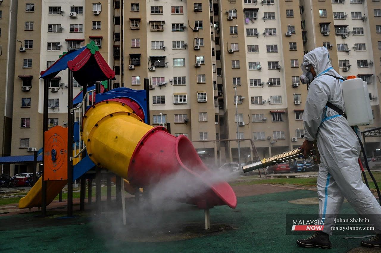 A member of a volunteer team sprays disinfectant at a playground near the Pudu Ulu low-cost flats in Kuala Lumpur. The US Centres for Disease Control and Prevention recently said that the risk of contracting Covid-19 by touching contaminated surfaces is less than one in 10,000.