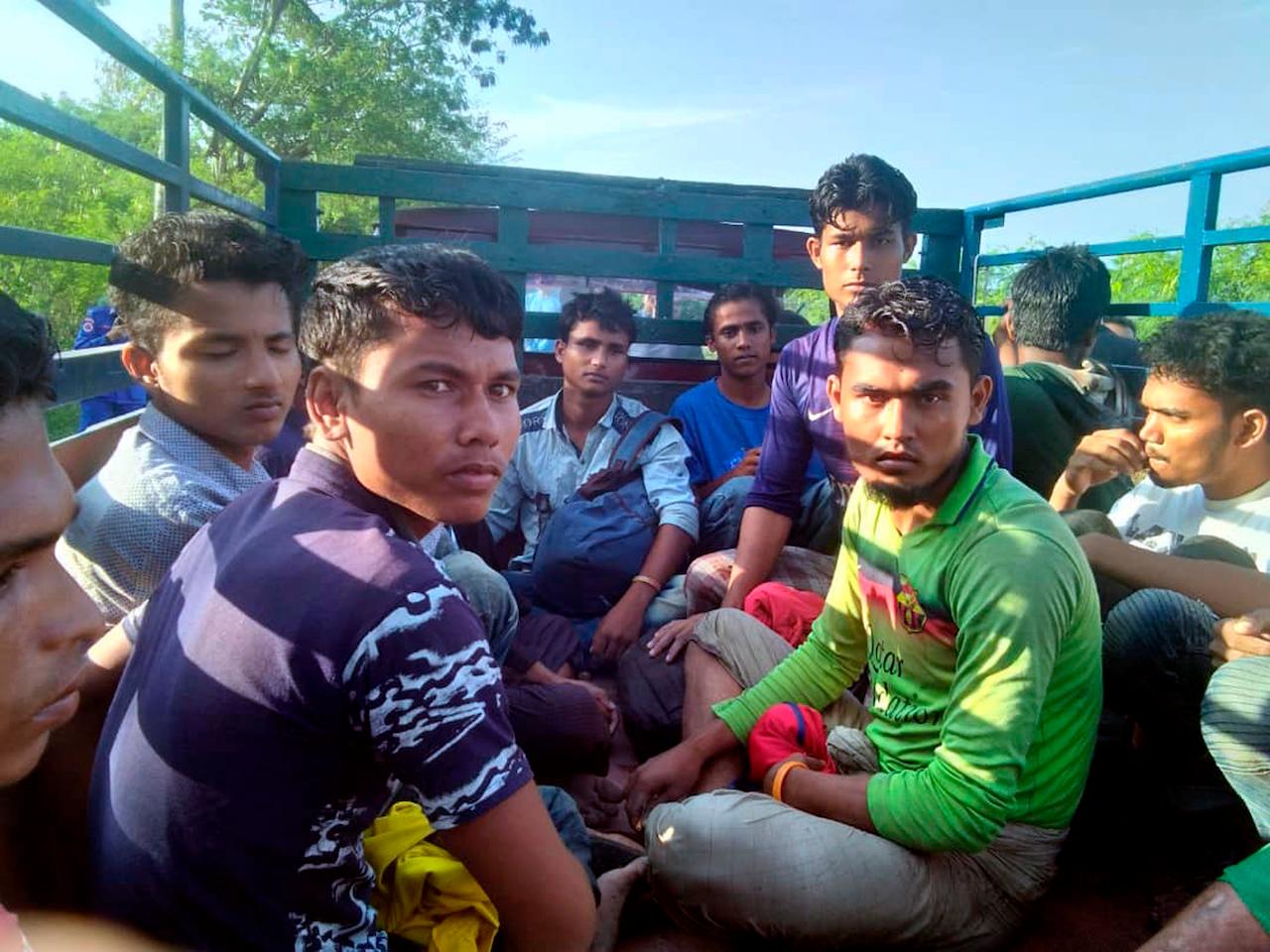 Dozens of men believed to be Rohingya from Myanmar are brought by truck to a police station in Perlis in this photo released April 8, 2019. Malaysia's treatment of refugees and migrants re-entered the spotlight at the height of the movement control order last year. Photo: AP