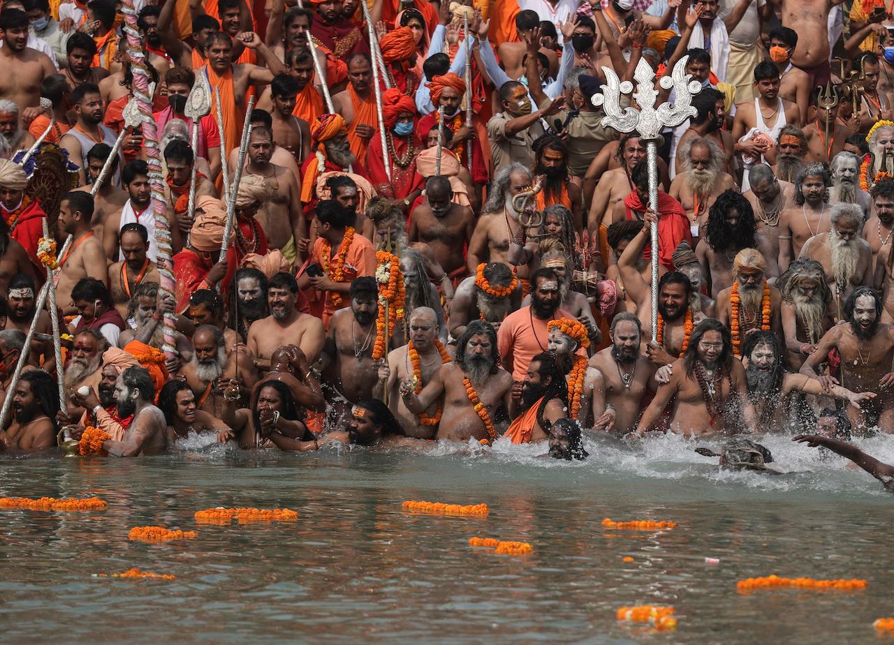 Naked Hindu holy men take a dip in the Ganges River during Kumbh Mela, or the pitcher festival, one of the most sacred pilgrimages in Hinduism, in Haridwar, northern state of Uttarakhand, India, April 12. Photo: AP