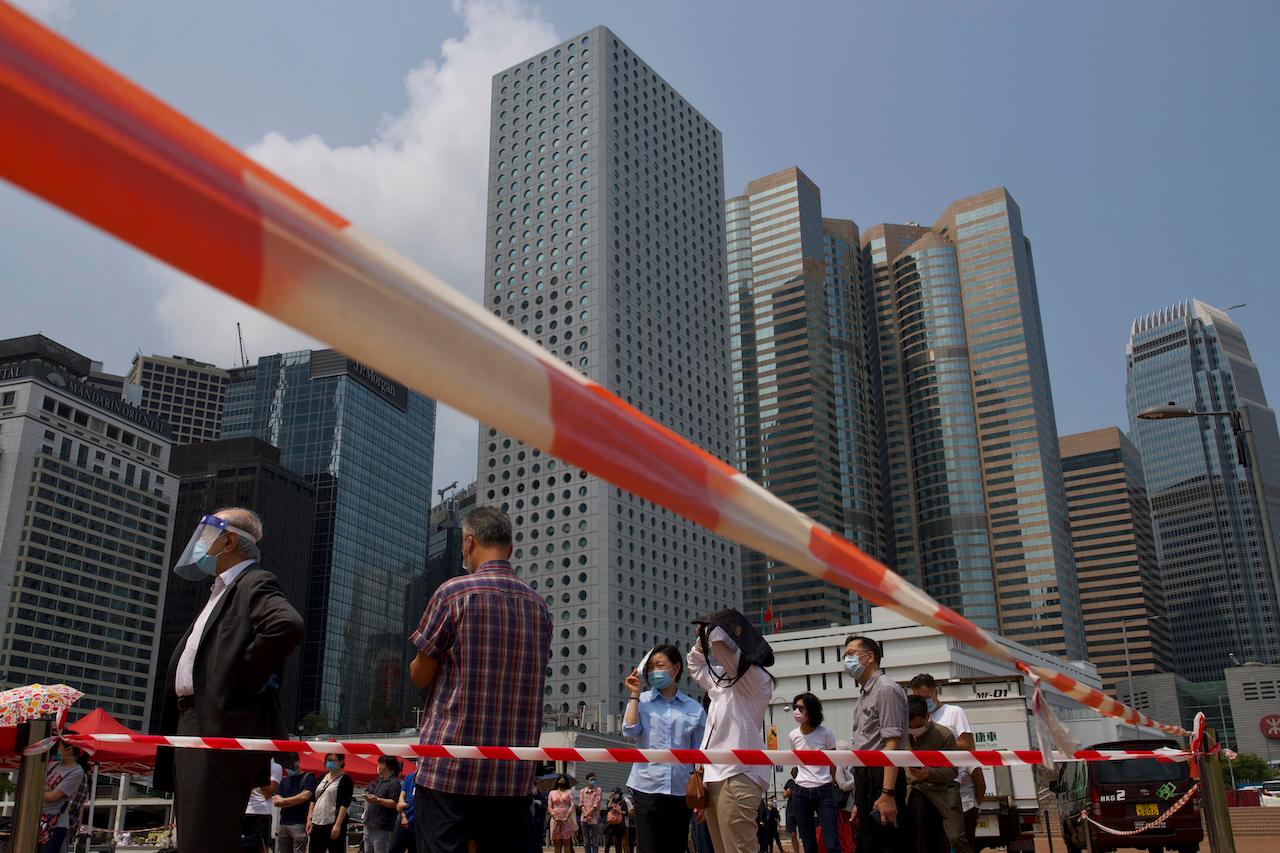 Residents line up at Hong Kong's business district to get tested for Covid-19 at a temporary testing centre, March 16. Hong Kong has recorded more than 11,600 cases in total and 209 deaths. Photo: AP