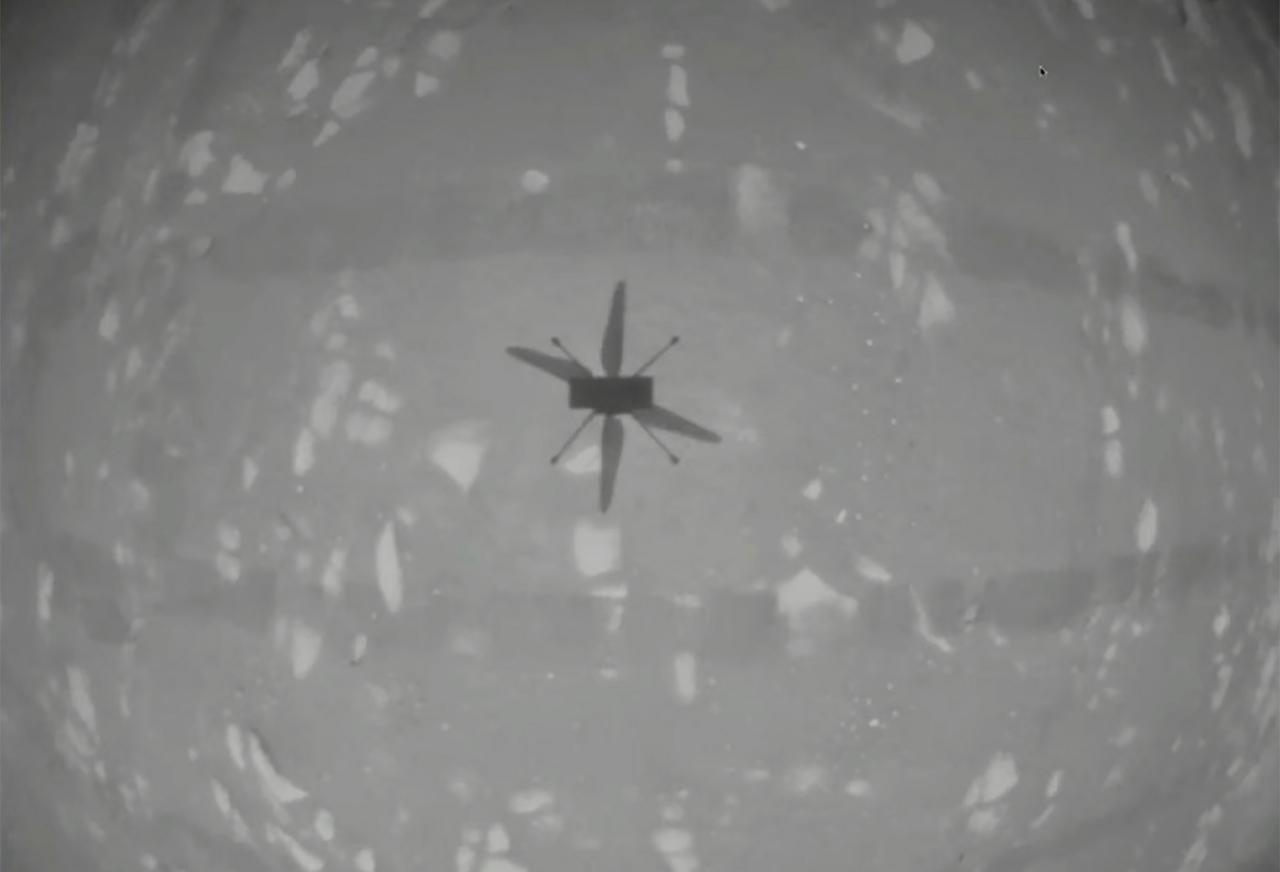 Nasa's experimental Mars helicopter Ingenuity hovers above the surface of Mars, April 19. The little four-pound helicopter rose from the dusty red surface into the thin Martian air Monday, achieving the first powered, controlled flight on another planet. Photo: AP