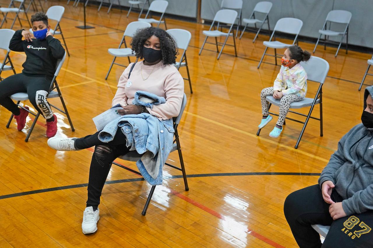A family waits at a vaccination centre in West New York, New Jersey, April 19. All adults in the US are now eligible for vaccination against Covid-19. Photo: AP