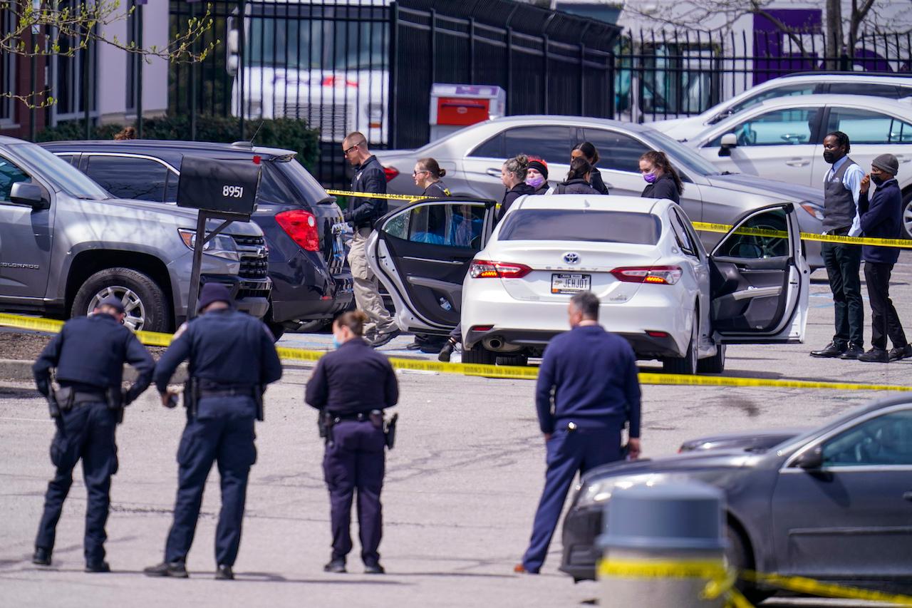 Law enforcement members confer at the scene in Indianapolis, where multiple people were shot at a FedEx Ground facility near the Indianapolis airport, April 16. Photo: AP