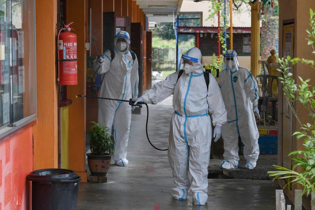 Health workers santise a school in Terengganu which was ordered to close earlier this year after staff members tested positive for Covid-19. Another 19 schools in Selangor have been ordered to close as well following the emergence of virus clusters. Photo: Bernama