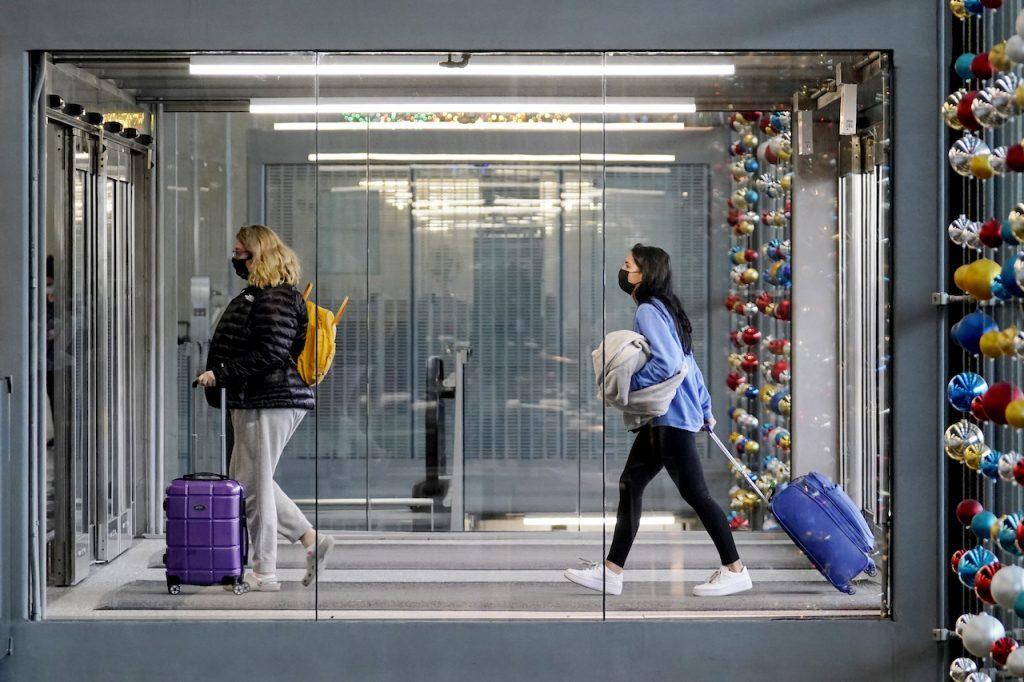 Travellers walk through Terminal 3 at O'Hare International Airport in Chicago, Nov 29, 2020. European Union member states have agreed on vaccine certificates, China has launched a health certificate programme for travellers and airline companies are also considering requiring vaccination proof. Photo: AP