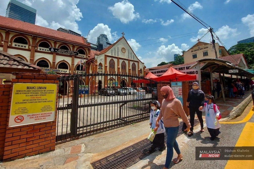 Parents pick up their children from the Convent Bukit Nanas girls' school in Kuala Lumpur. Established in 1899, the school is said to be one of the oldest in the country.