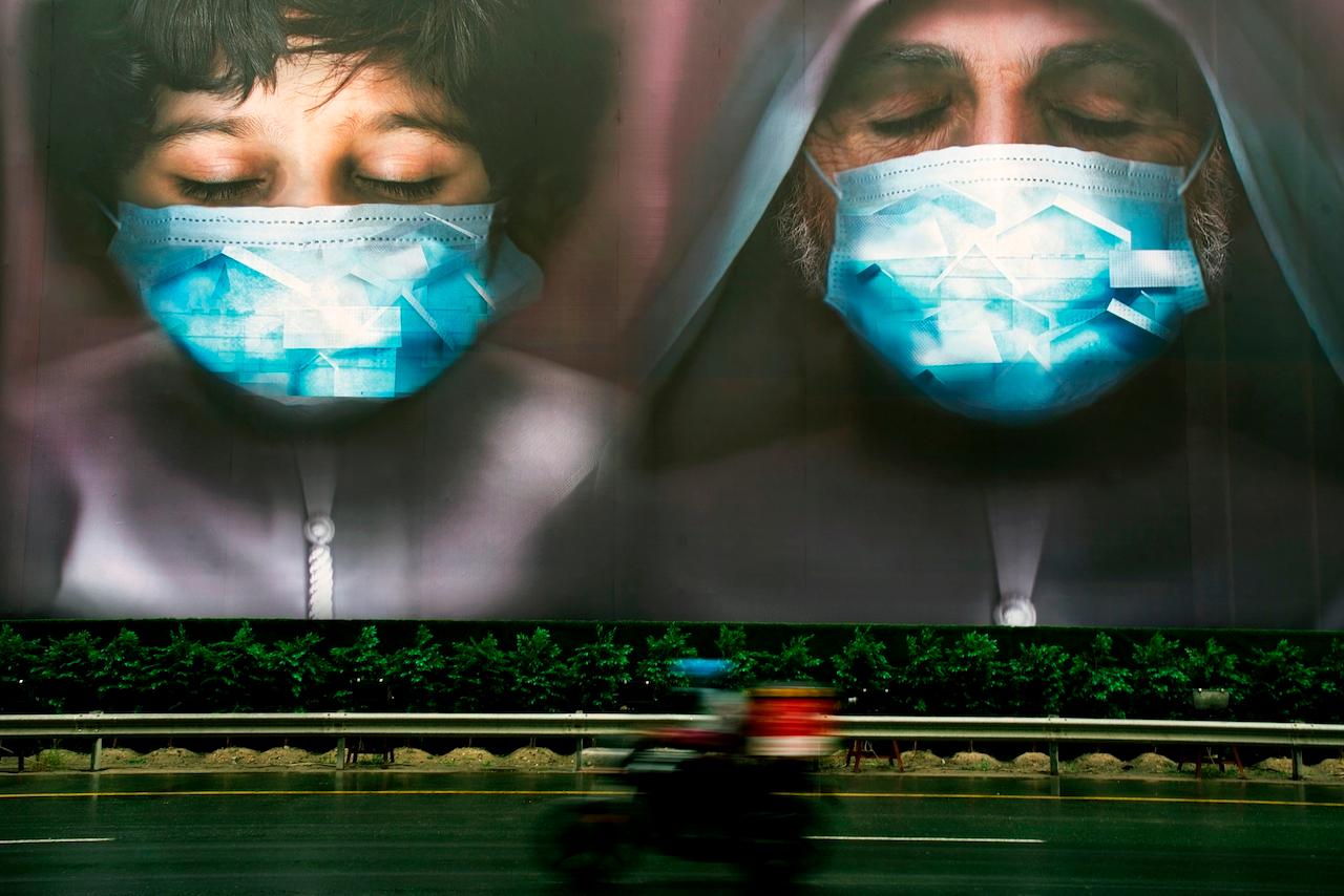 A billboard urges people to stay home during the coronavirus pandemic in Dubai, United Arab Emirates, April 15, 2020. Authorities in the UAE say anyone opting against vaccination will face unspecified penalties. Photo: AP