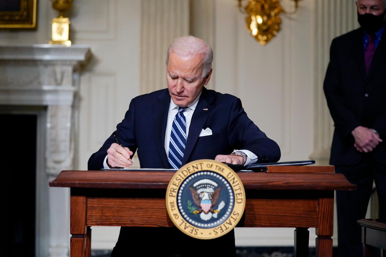 US President Joe Biden signs an executive order on climate change at the White House in Washington, Jan 27. Biden rejoined the Paris climate agreement on his first day in office and has made climate change a key focus of his administration. Photo: AP