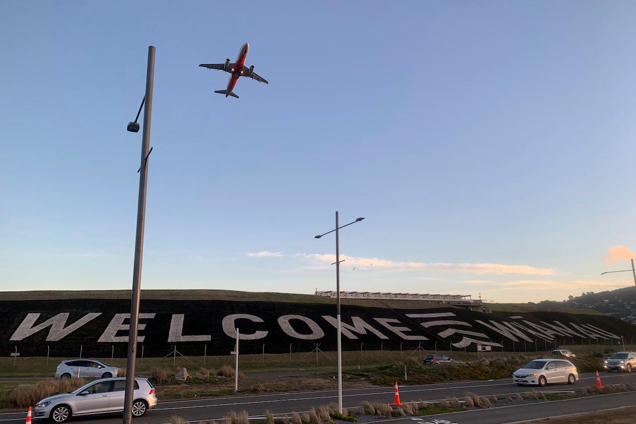 A giant sign painted near the main runway of the Wellington International Airport greets travellers returning home in Wellington, New Zealand, April 19. The travel bubble between Australia and New Zealand has been paused pending further advice from the state government. Photo: AP