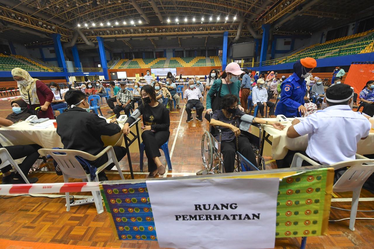 People who have received their first dose of Covid-19 vaccine wait in the observation area at the Sultan Abdul Halim Stadium in Alor Setar, Kedah. Photo: Bernama