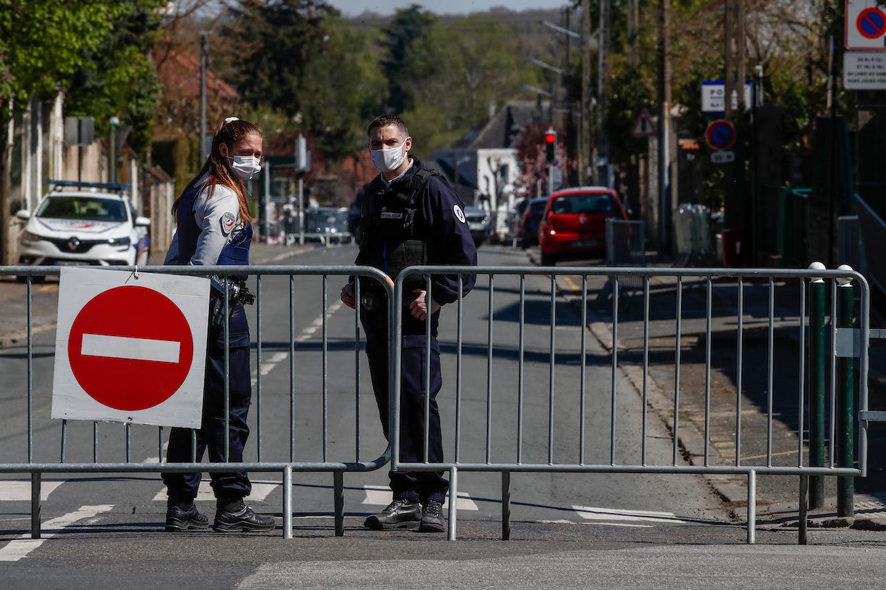 French police officers block the access next to the police station where a police official was stabbed to death Friday in Rambouillet, south west of Paris, April 24. Photo: AP