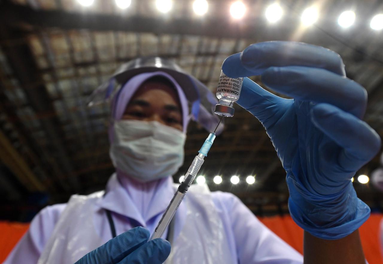 A health worker prepares a syringe of Covid-19 vaccine to be administered to senior citizens under Phase Two of the government's vaccination programme at Stadium Tertutup Sultan Abdul Halim in Alor Setar, Kedah. Photo: Bernama