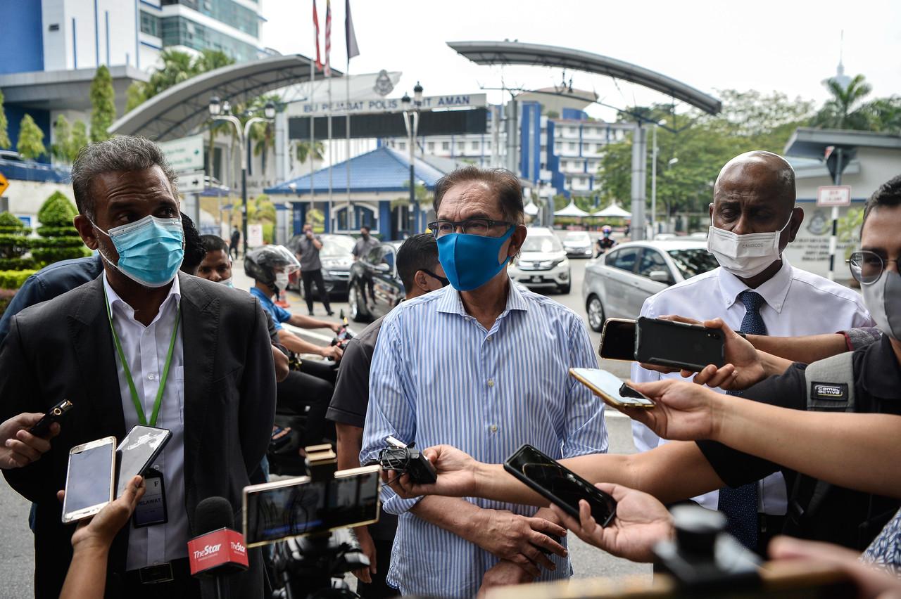 PKR president Anwar Ibrahim speaks to reporters at the Bukit Aman police headquarters in Kuala Lumpur today. Photo: Bernama