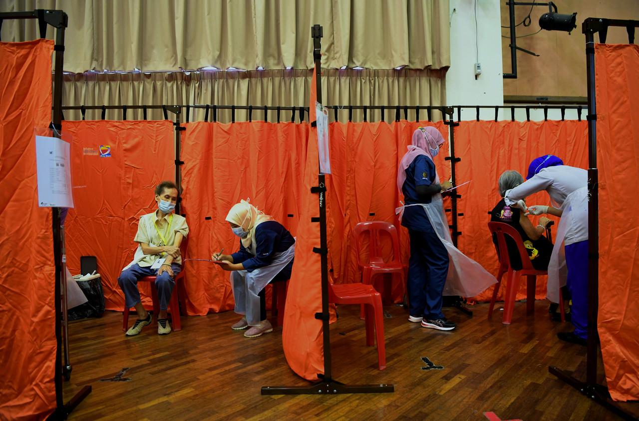 Senior citizens and those from the high-risk group receive their first dose of Covid-19 vaccine under Phase Two of the national immunisation programme at Wisma Belia in Kuantan, Pahang. Photo: Bernama