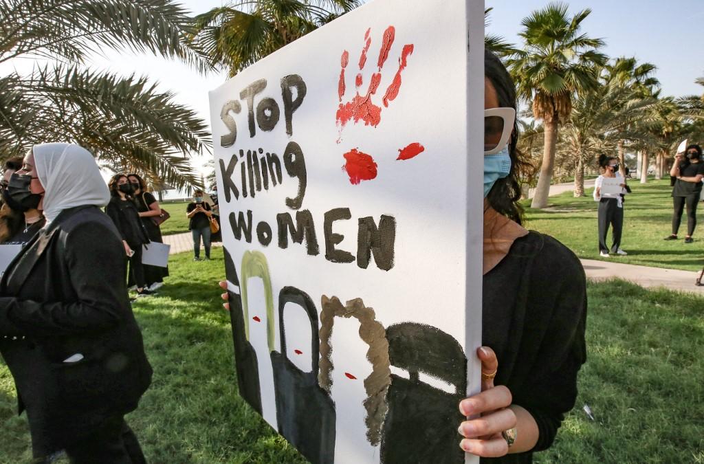 Kuwaiti women carry a banner during a rally to denounce violence against women outside the National Assembly in the capital Kuwait City, April 22. The women demonstrated after Farah Hamaza, a 32-year-old Kuwaiti woman, was killed by a young man despite her filing several complaints against him. Photo: AFP