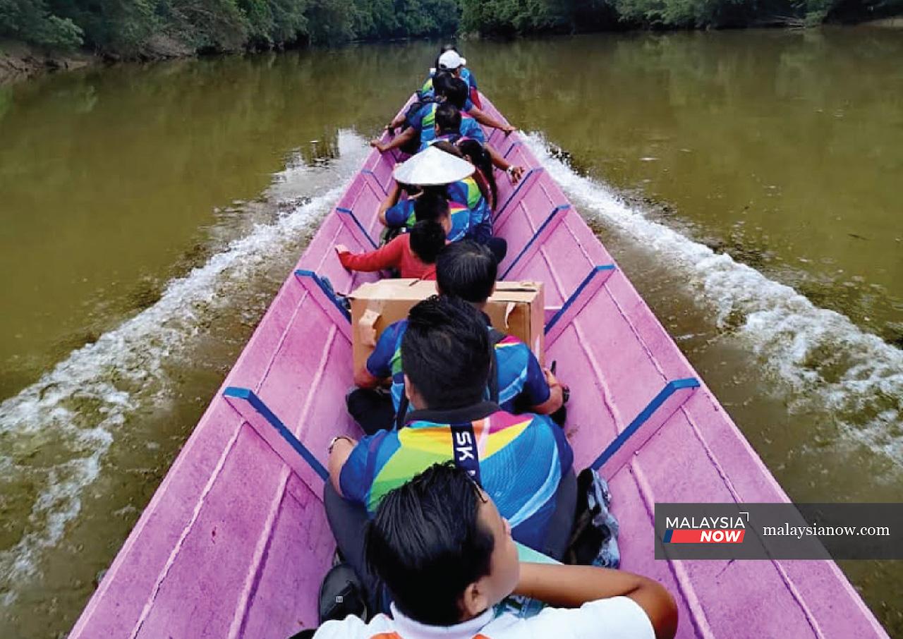 Teachers from SK Nanga Oyan make the long trip by boat in the crocodile-infested waters of Sungai Rajang to see their students safely home.
