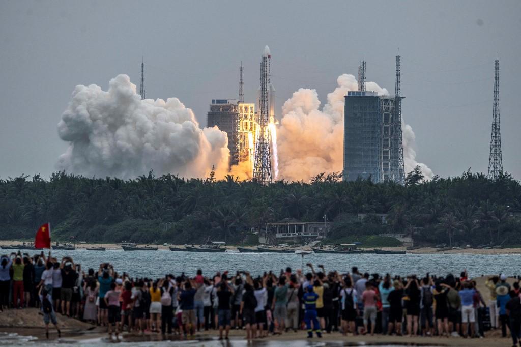 People watch a Long March-5B rocket, carrying China's Tianhe space station core module, as it lifts off from the Wenchang Space Launch Center in southern China's Hainan province on April 29. Photo: AFP