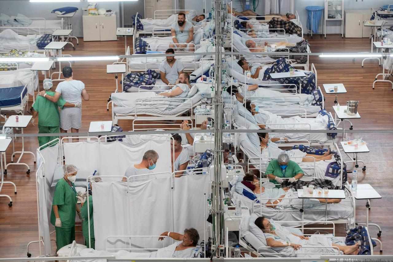 Covid-19 patients rest in a field hospital built inside a sports coliseum in Santo Andre, on the outskirts of Sao Paulo, Brazil, March 4. Almost 3.2 million deaths linked to Covid-19 have been recorded across the globe. Photo: AP