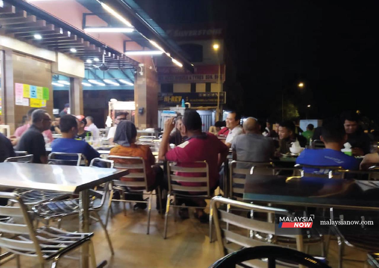 Diners linger long past midnight at a mamak restaurant in Wangsa Maju, Kuala Lumpur, taking full advantage of the green light for eateries to operate until 6am.