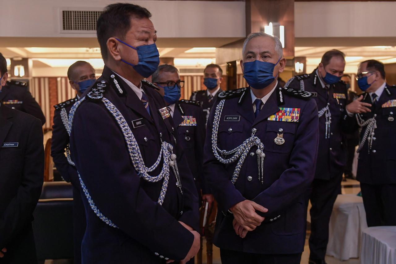 Former top cop Abdul Hamid Bador with newly appointed Inspector-General of Police Acryl Sani Abdullah Sani after the handover of duties in Kuala Lumpur today. Photo: Bernama