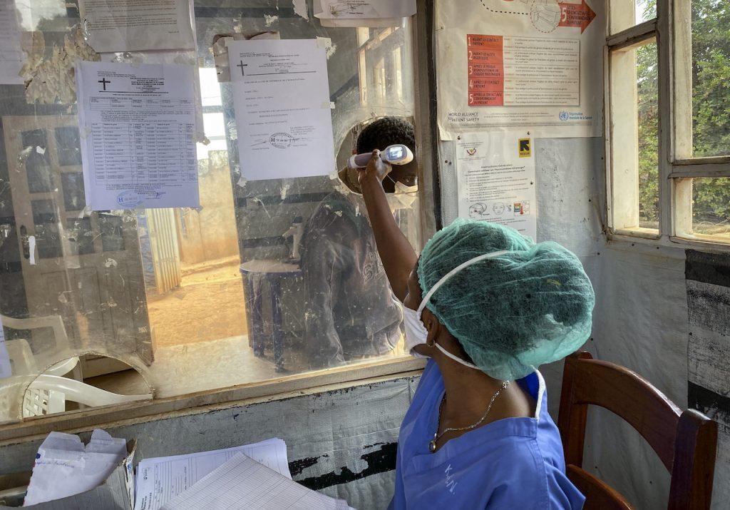 A medical worker checks a person's temperature at the Matanda Hospital in Butembo, where the first case of Ebola died, in the North Kivu province of Congo, Feb 11. Photo: AP