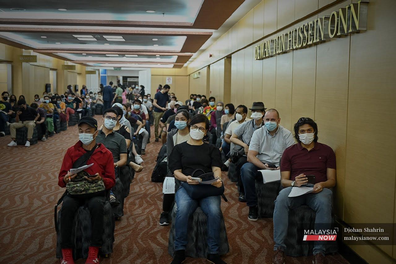 Residents in Selangor and Kuala Lumpur who volunteered to receive the AstraZeneca vaccine for Covid-19 wait for their turn at the World Trade Centre in Kuala Lumpur today.