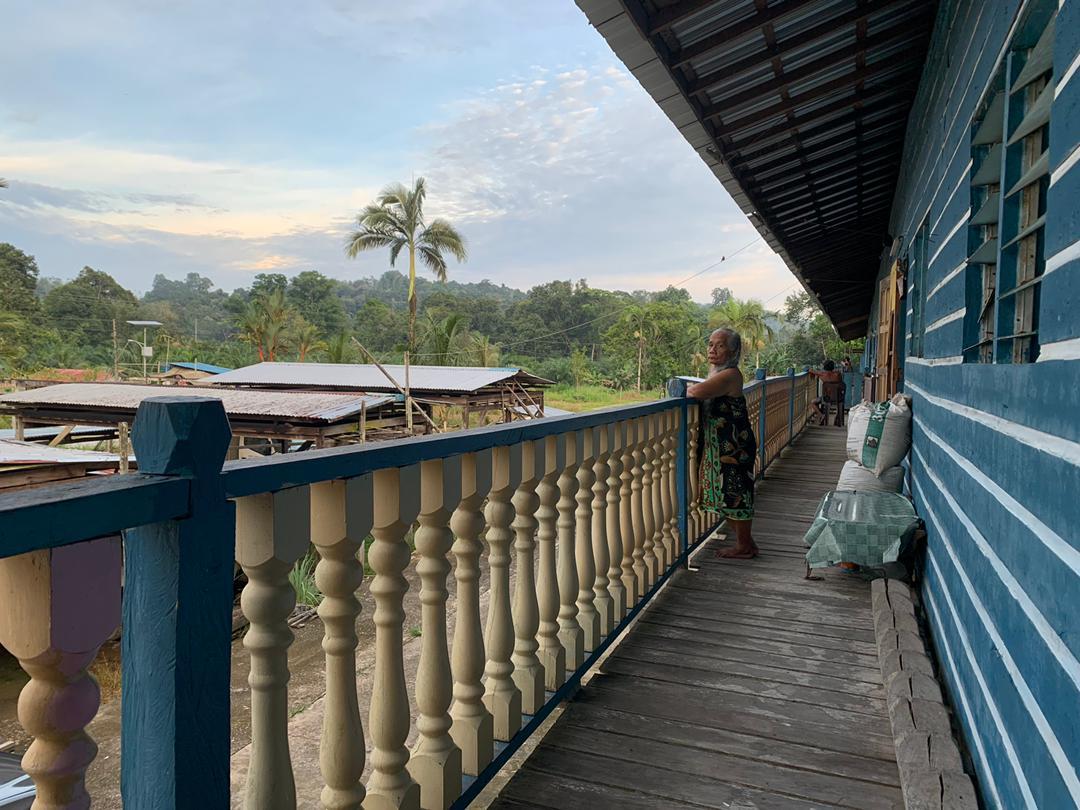 A woman stands at the verandah of a longhouse in Maradong, a district in the Sarikei division of Sarawak. Sarawak has been struggling to contain a surge in Covid-19 cases, with many clusters linked to social activities within the community.