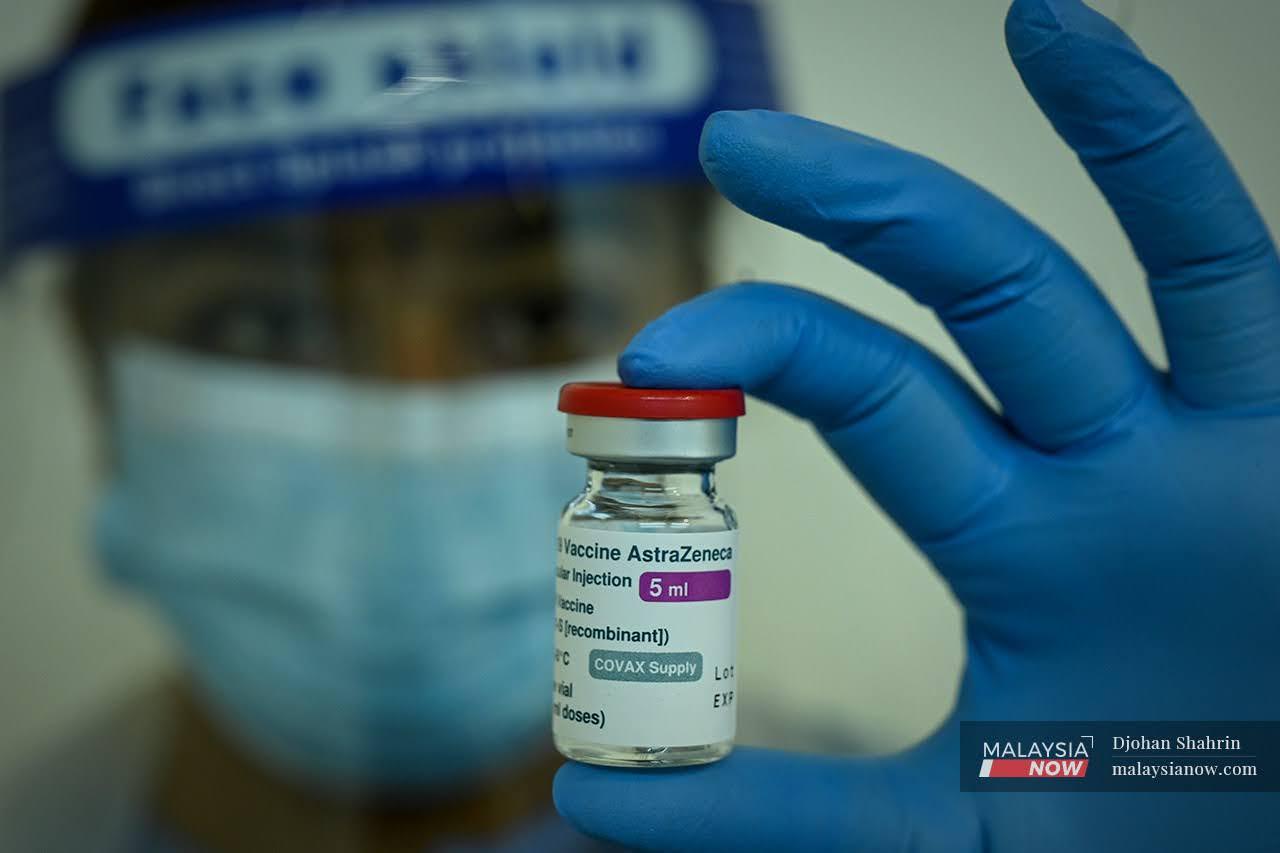 Pegawai perubatan menunjukkan botol vaksin AstraZeneca yang akan diberikan kepada penduduk di Kuala Lumpur dan Selangor di Pusat Dagangan Dunia Putra.
