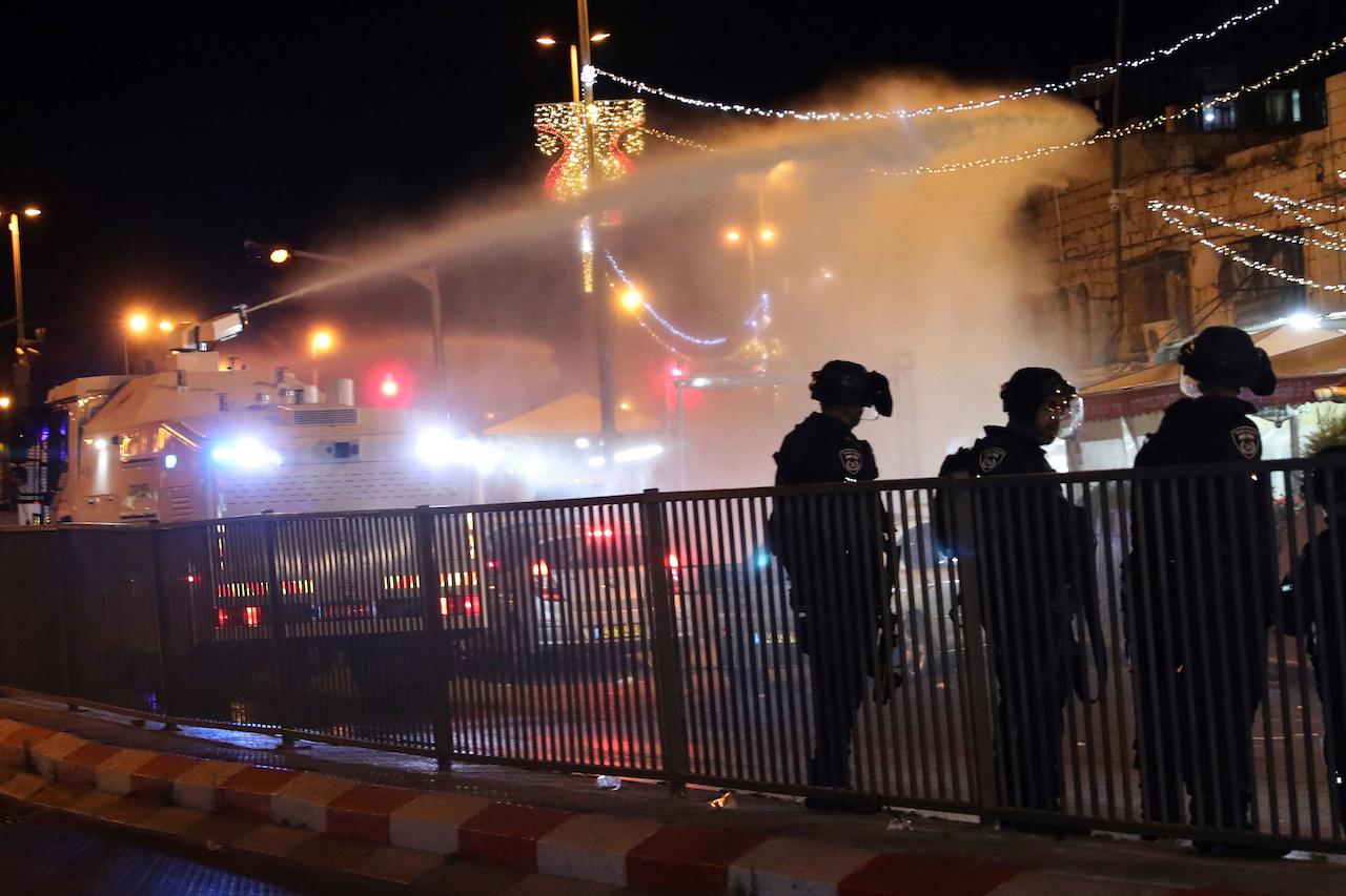 Israeli police use a water cannon to disperse Palestinian protesters from the area near the Damascus Gate to the Old City of Jerusalem after clashes at the Al-Aqsa Mosque compound, May 7. Photo: AP