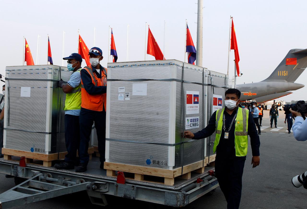 Workers pull boxes loaded with Covid-19 vaccines from China at Phnom Penh International Airport, in Phnom Penh, Cambodia, Feb 7. Beijing has been making such donations to several Southeast Asian and African nations in what has been dubbed 'vaccine diplomacy', aimed especially at poorer countries like Cambodia. Photo: AP