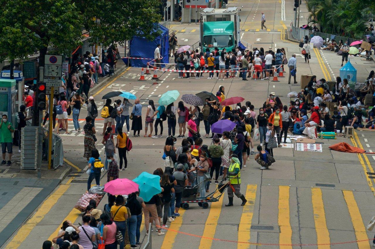 Domestic helpers from the Philippines line up at a temporary testing centre for Covid-19, in Hong Kong, May 1. Photo: AP