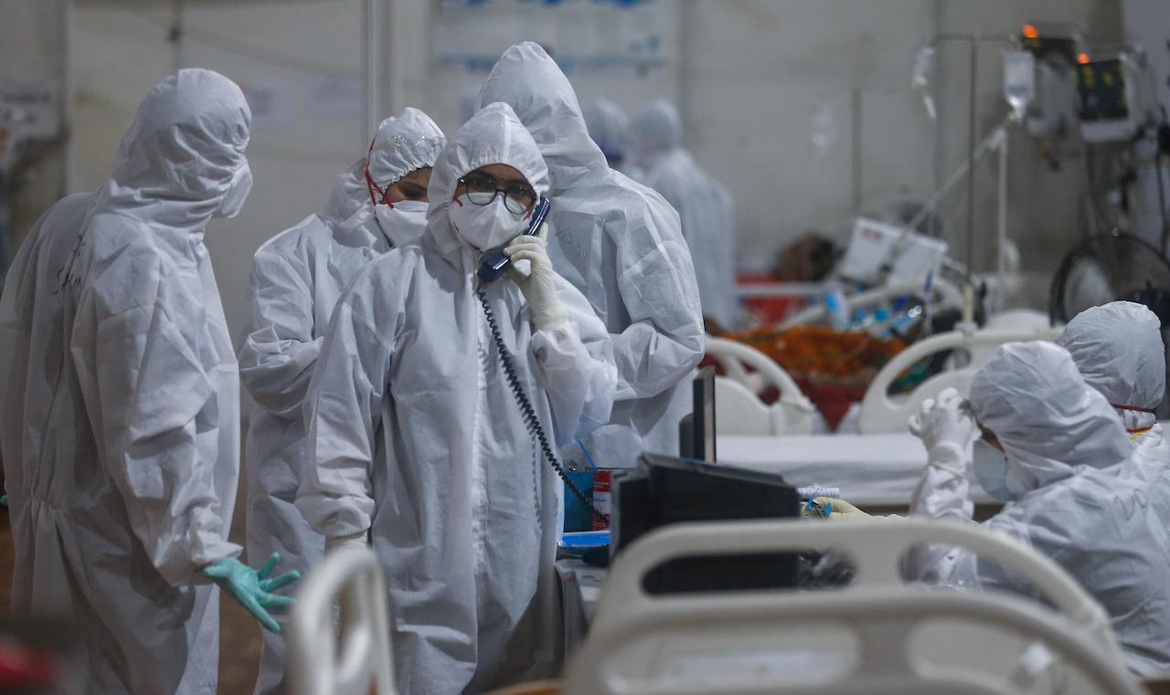 A doctor speaks on the intercom with a senior consultant giving an update of a patient at the BKC jumbo field hospital, one of the largest Covid-19 facilities in Mumbai, India, May 6. Photo: AP