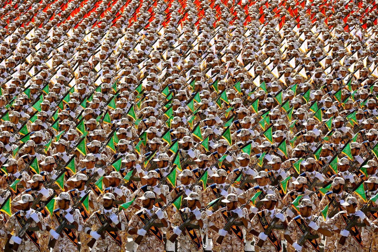 Members of Iran's Revolutionary Guard march during an annual military parade at the mausoleum of Ayatollah Khomeini, outside Tehran, Iran, Sept 22, 2014. Tehran has been accused of arresting foreign nationals on trumped-up charges and using them as hostages in an effort to win concessions from other countries. Photo: AP