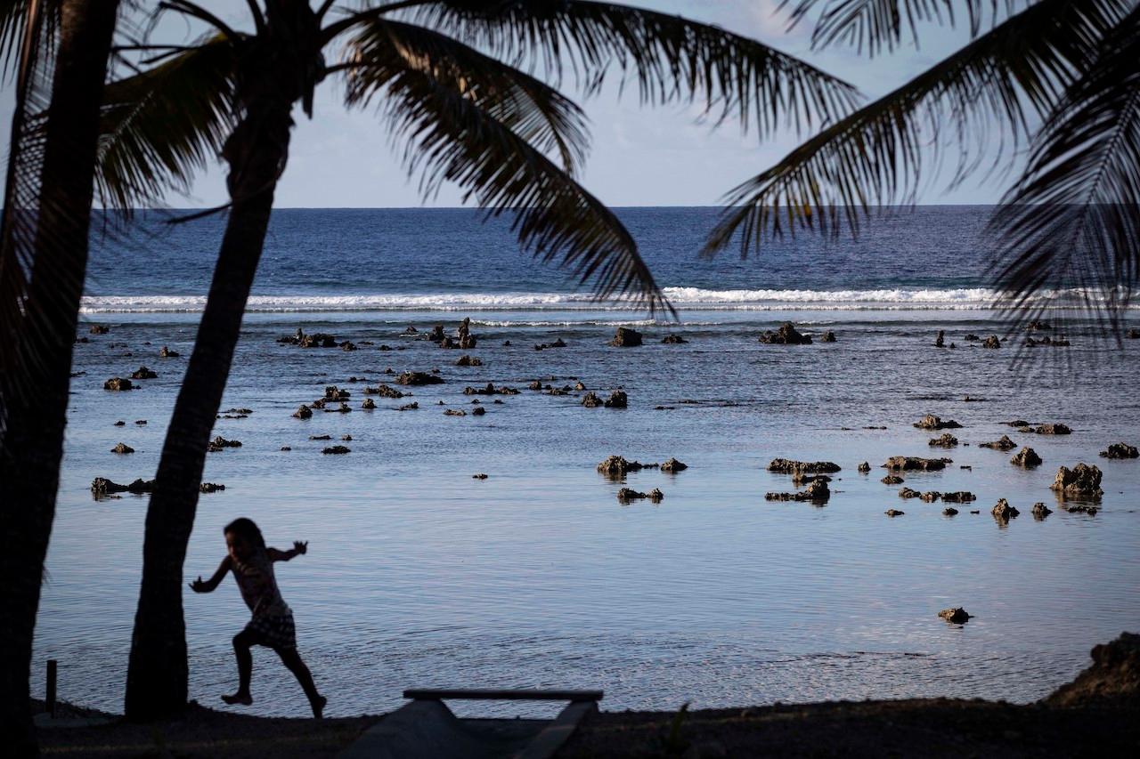 A child plays near the beach in Nauru in this Sept 3, 2018 file photo. Nauru has completely vaccinated its adult population against the Covid-19 virus. Photo: AP