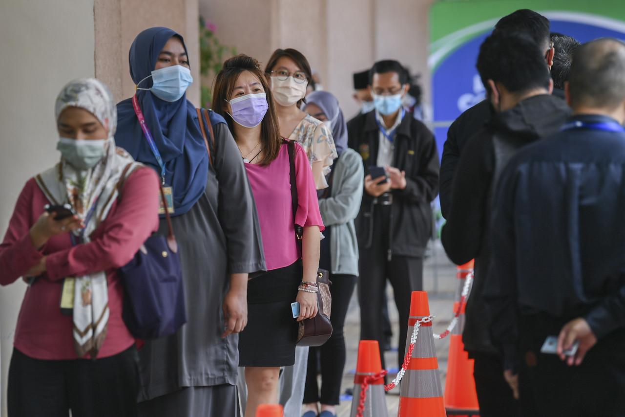 Frontline workers queue for their vaccination appointments at a centre in Putrajaya. Photo: Bernama