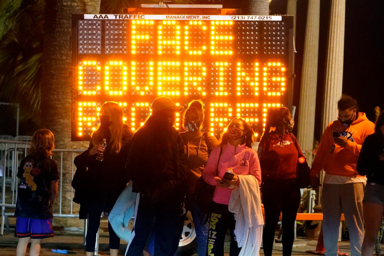 A sign encourages visitors to wear face masks amid the Covid-19 pandemic, Feb 19, in Santa Monica, California. Photo: AP