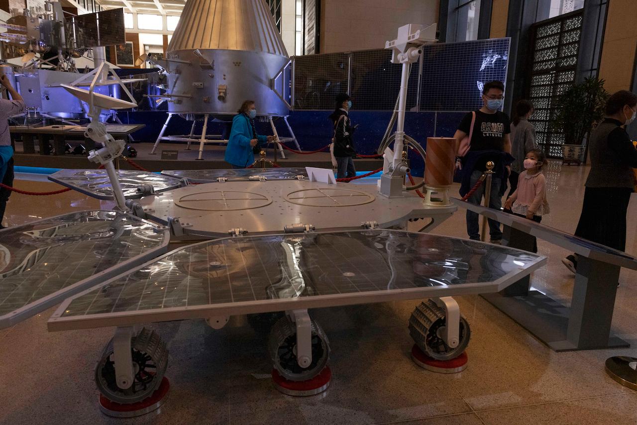 Visitors to an exhibition on China's space programme look at a life-size model of the Chinese Mars rover Zhurong, named after the Chinese god of fire, at the National Museum in Beijing on May 6. China has landed a spacecraft on Mars for the first time in the latest advance for its space programme. Photo: AP