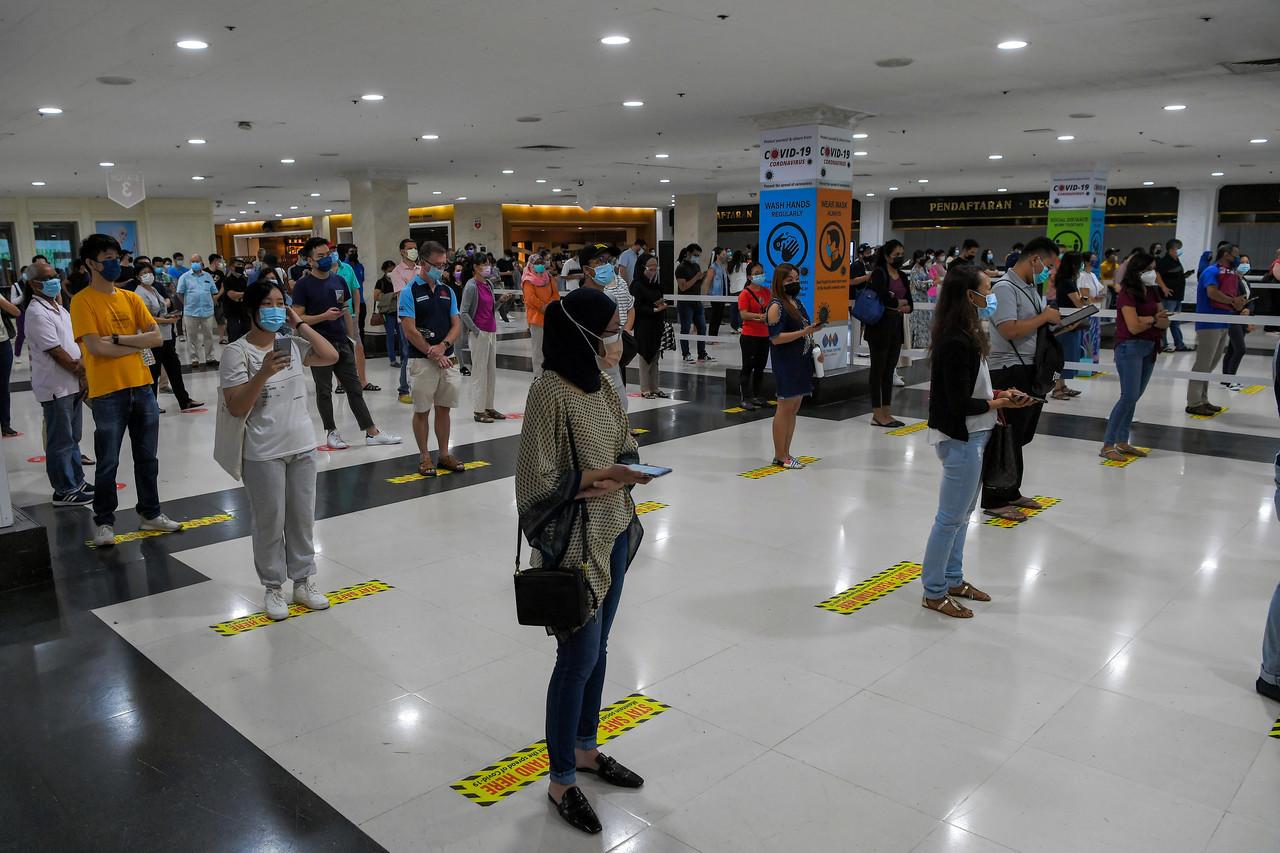People stand in line to receive the AstraZeneca vaccine at the World Trade Centre in Kuala Lumpur. Photo: Bernama